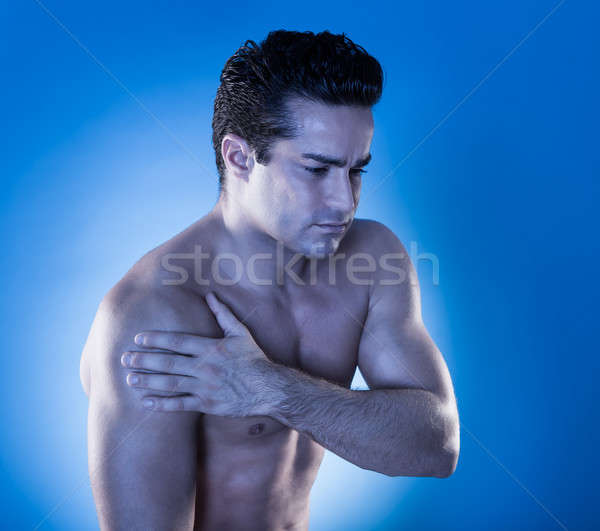 Joven sufrimiento dolor en el hombro primer plano muscular hombre Foto stock © AndreyPopov