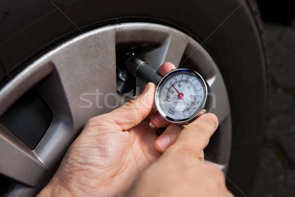 Mechanic Checking Tire Pressure Using Gauge Stock photo © AndreyPopov