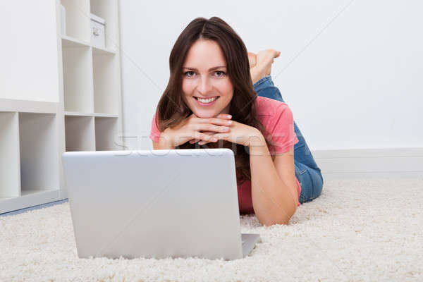 Woman Lying On Floor In Front Of Laptop Stock photo © AndreyPopov