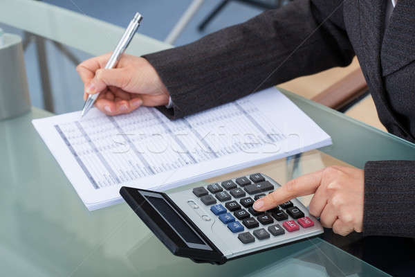 Businesswoman Calculating Tax Stock photo © AndreyPopov