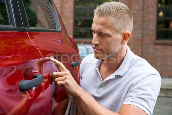 [[stock_photo]]: Homme · regarder · voiture · jeune · homme · rouge