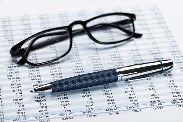 Financial Data Sheet With Eyeglasses And Pen Stock photo © AndreyPopov