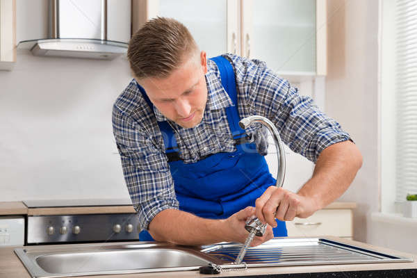 Repairman Installing Faucet Of Kitchen Sink Stock photo © AndreyPopov