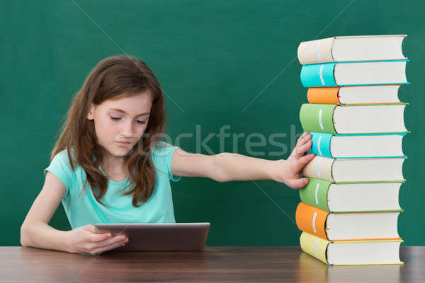 Girl Using Digital Tablet And Avoiding Books Stock photo © AndreyPopov