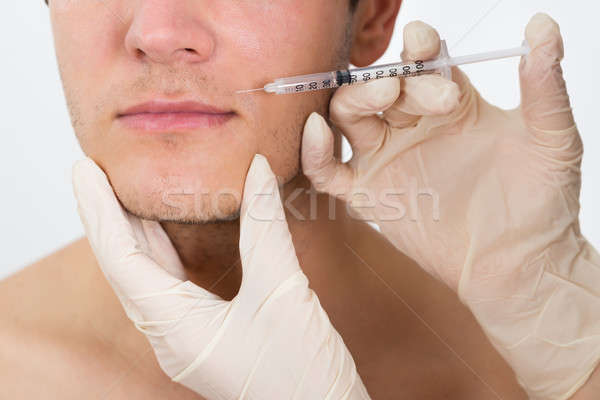 Man Getting Cosmetic Injection In His Face Stock photo © AndreyPopov