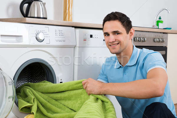 Man Loading Towels In Washing Machine Stock photo © AndreyPopov