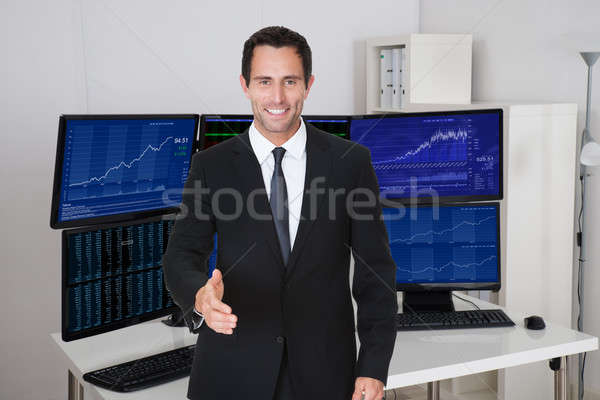 Broker Offering Handshake Against Multiple Monitors Stock photo © AndreyPopov