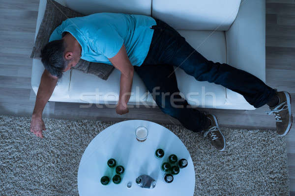 Hombre toma siesta sofá casa hombre maduro Foto stock © AndreyPopov