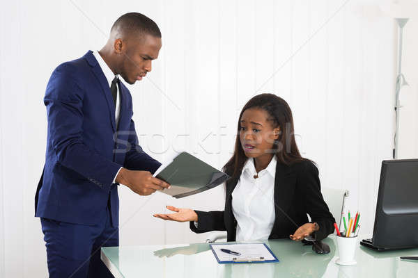 Boss Showing Document To Her Female Executive Stock photo © AndreyPopov