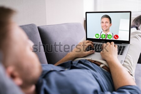 Man Playing Action Game On Digital Tablet Stock photo © AndreyPopov