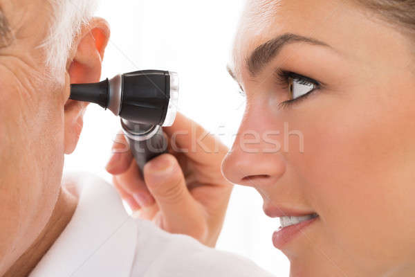 Női orvos megvizsgál fül közelkép férfi Stock fotó © AndreyPopov