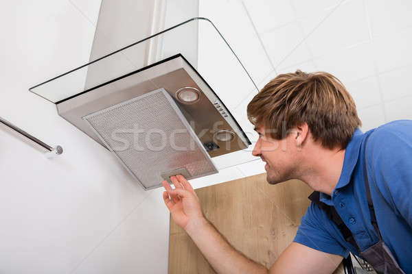 Repairman Repairing Kitchen Extractor Filter Stock photo © AndreyPopov