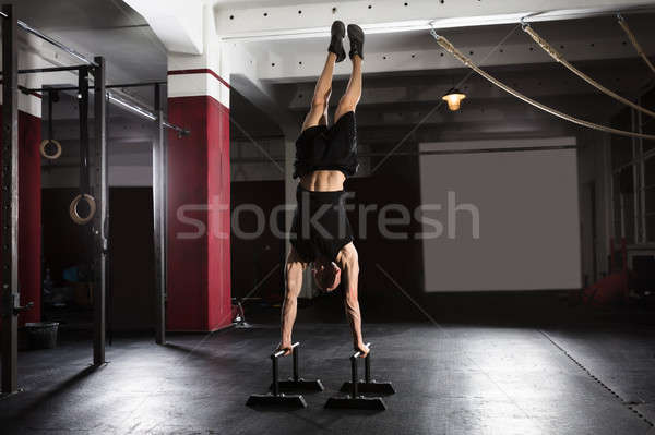 Adam amuda kalkma paralel bar genç atlet Stok fotoğraf © AndreyPopov