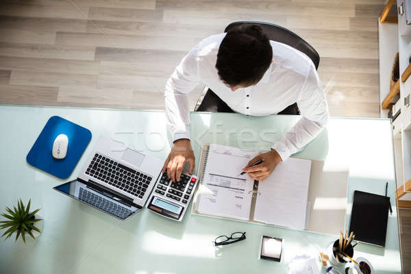 Happy businessman calculating invoice Stock photo © AndreyPopov