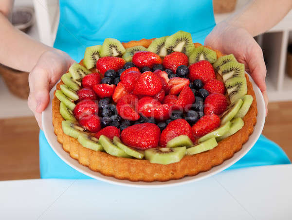 Woman holding self-made cake Stock photo © AndreyPopov