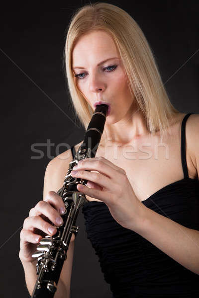 Beautiful young woman playing clarinet Stock photo © AndreyPopov