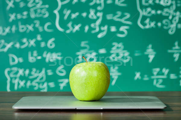 Laptop and apple on the desk Stock photo © AndreyPopov