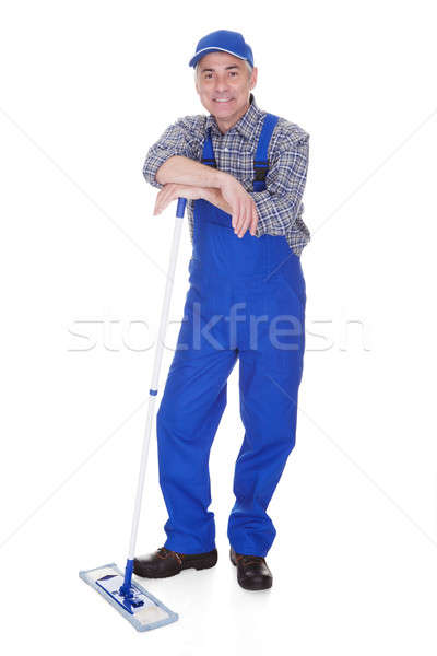 Mature Man Cleaning Floor With Mop Stock photo © AndreyPopov