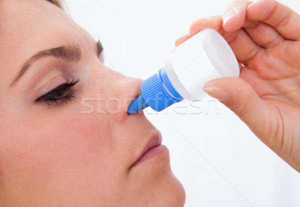 Woman using nasal spray Stock photo © AndreyPopov