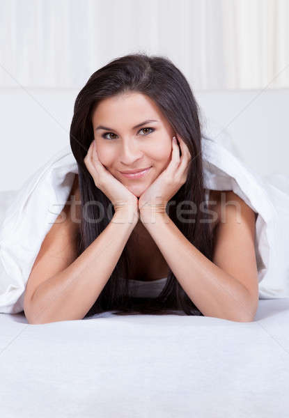 Smiling woman resting her chin on her hands Stock photo © AndreyPopov