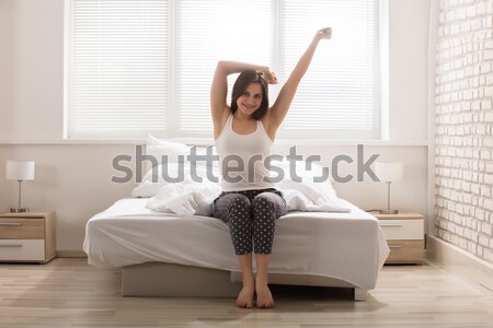Happy woman sitting on a couch rejoicing Stock photo © AndreyPopov