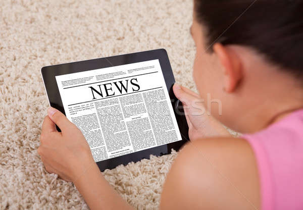 Young Woman Reading A News Article On Digital Tablet  Stock photo © AndreyPopov