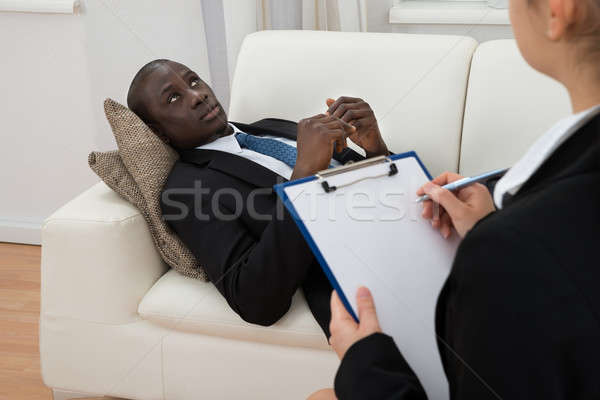 Psychiatra zauważa pacjenta kobiet terapii Zdjęcia stock © AndreyPopov