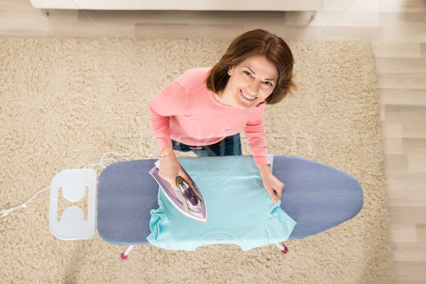 Woman Ironing Clothes With Steam Iron Stock photo © AndreyPopov