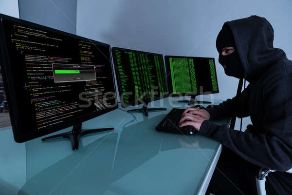 Hacker Stealing Data On Multiple Computers Stock photo © AndreyPopov