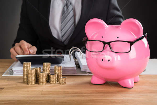 Businessman Calculating Tax On Desk Stock photo © AndreyPopov