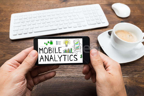 Person Holding Mobilephone Showing Mobile Analytic Concept Stock photo © AndreyPopov