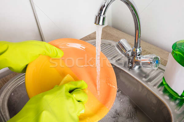 Close-up Of Person Washing Plate Stock photo © AndreyPopov