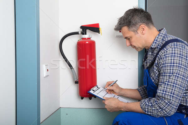 Professional Checking A Fire Extinguisher Stock photo © AndreyPopov