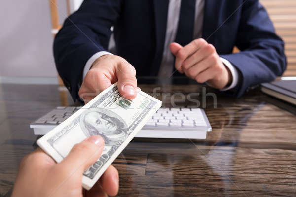 Businessperson Taking Bribe In Office Stock photo © AndreyPopov
