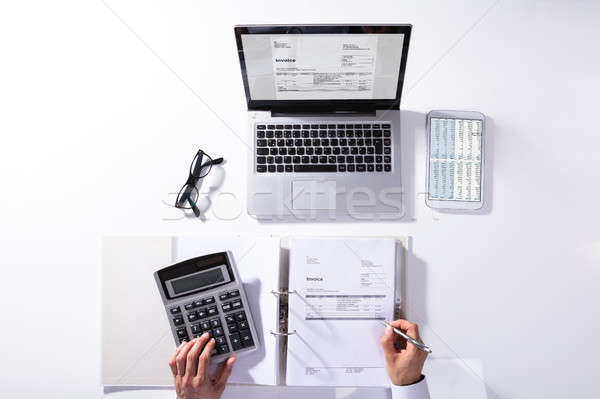 High Angle View Of Businessperson Calculating Invoice Stock photo © AndreyPopov