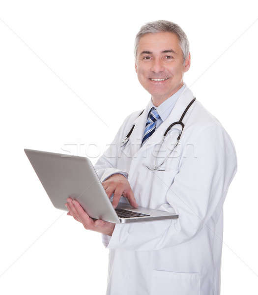 Stock photo: Portrait Of Male Doctor Using Laptop