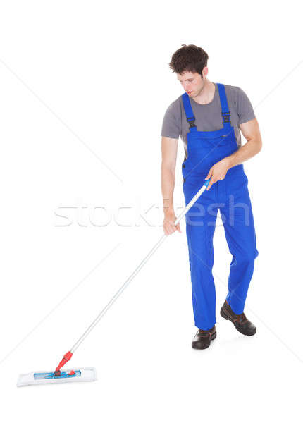 Young Man Cleaning With Mop Stock photo © AndreyPopov