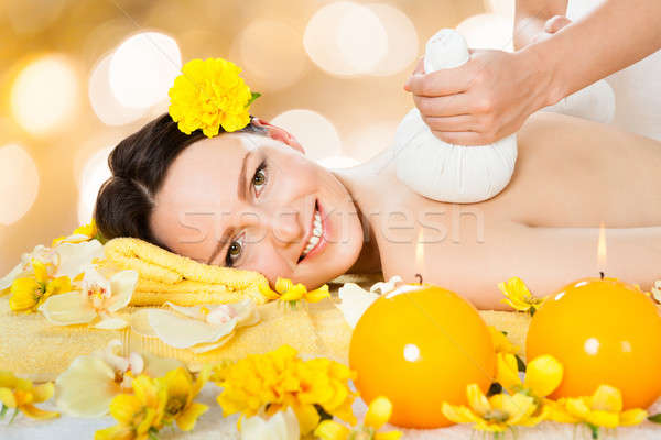 Beautiful Woman Receiving Massage With Herbal Compress Balls Stock photo © AndreyPopov