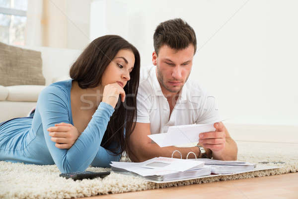 Worried Young Couple Calculating Their Bills At Home Stock photo © AndreyPopov