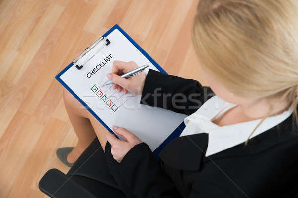 Businesswoman Marking Checklist Stock photo © AndreyPopov