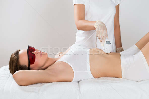 Woman Receiving Epilation Laser Treatment On Tummy Stock photo © AndreyPopov