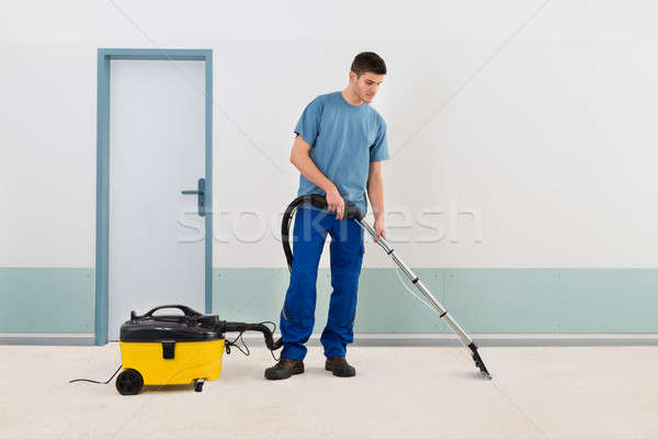 Male Cleaner Vacuuming Floor Stock photo © AndreyPopov
