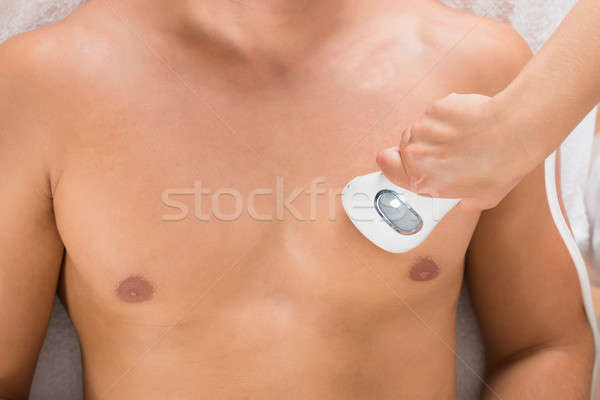 Stock photo: Beautician Giving Laser Epilation On Man's Chest