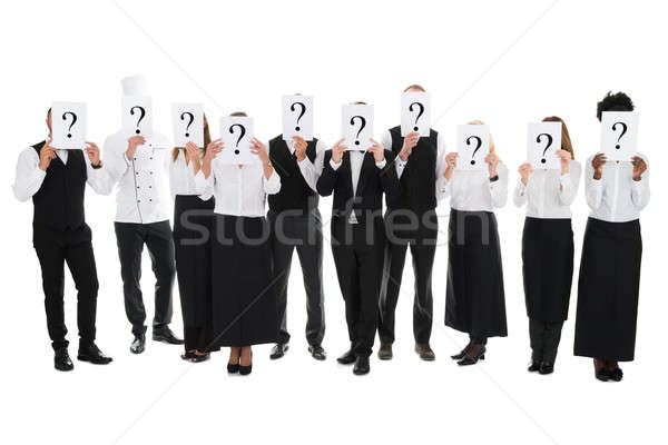 Restaurant Staff Hiding Faces With Question Mark Signs Stock photo © AndreyPopov