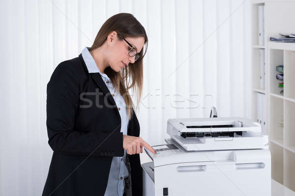 Businesswoman Using Copy Machine Stock photo © AndreyPopov