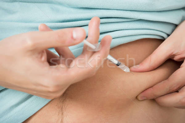Diabetic Man Injecting Stomach Stock photo © AndreyPopov