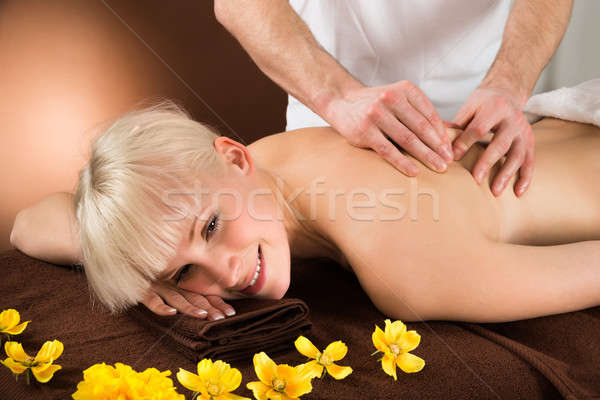 Młoda kobieta powrót masażu portret kobieta Zdjęcia stock © AndreyPopov