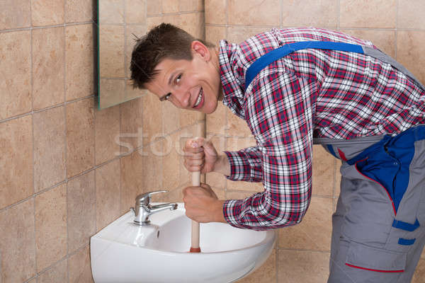 Male Plumber Using Plunger In Sink Stock photo © AndreyPopov
