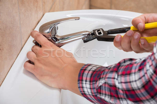 Plumber Installing Faucet Of Sink Stock photo © AndreyPopov