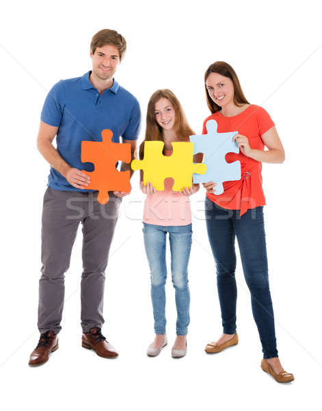 Family Holding Jigsaw Puzzle Pieces Stock photo © AndreyPopov